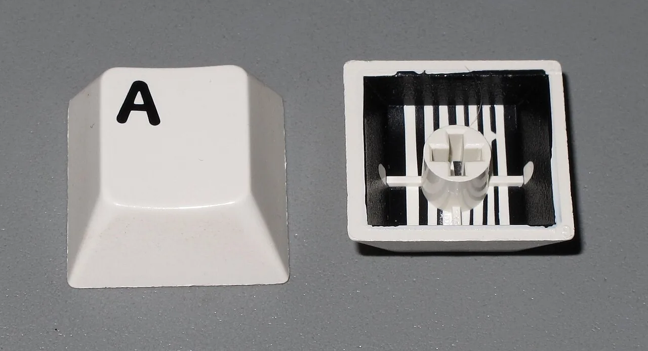 Rows of two-color computer keycaps produced by two-shot injection molding.